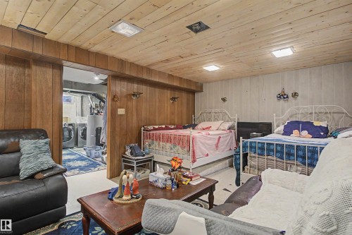 Wood-paneled walls and ceiling with integrated lighting - 5724 143 Avenue Nw, Edmonton, AB - Indoor Photo Showing Other Room