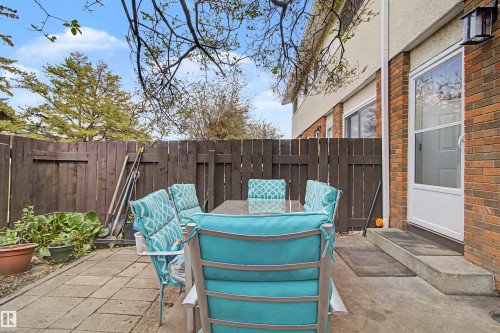 Private patio with paver stone and concrete surfaces, enclosed by a wood privacy fence - 5724 143 Avenue Nw, Edmonton, AB - Outdoor