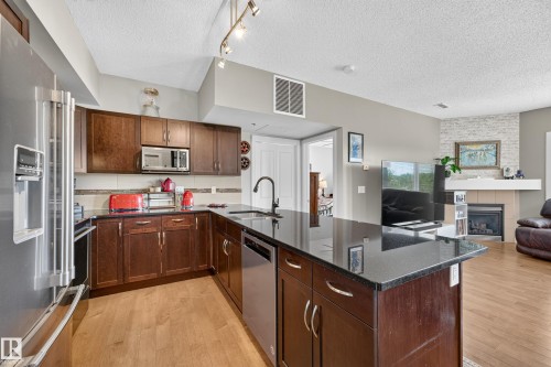 #115 35 Sturgeon Rd, St. Albert, AB - Indoor Photo Showing Kitchen With Fireplace With Stainless Steel Kitchen With Upgraded Kitchen