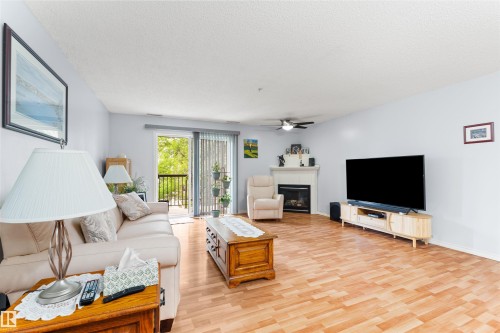 #218 2098 Blackmud Creek Dr Sw, Edmonton, AB - Indoor Photo Showing Living Room With Fireplace
