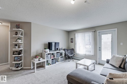 #203 111 Edwards Dr Sw, Edmonton, AB - Indoor Photo Showing Living Room