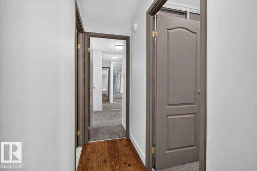 Hardwood flooring, painted interior doors, and overhead lighting - #506 12121 Jasper Av Nw, Edmonton, AB - Indoor Photo Showing Other Room