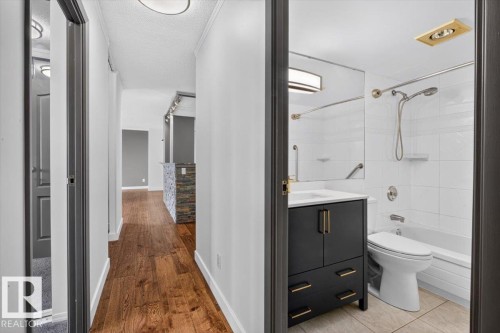 Hallway with wood-finish flooring and recessed lighting - #506 12121 Jasper Av Nw, Edmonton, AB - Indoor Photo Showing Bathroom