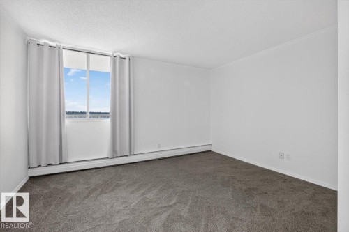 Expansive window with roller shades, neutral carpeting, and white walls - #506 12121 Jasper Av Nw, Edmonton, AB - Indoor Photo Showing Other Room