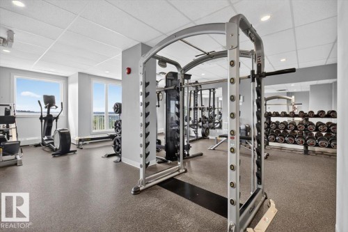 Recreational space featuring large windows, suspended ceiling, recessed lighting, and resilient flooring - #506 12121 Jasper Av Nw, Edmonton, AB - Indoor Photo Showing Gym Room