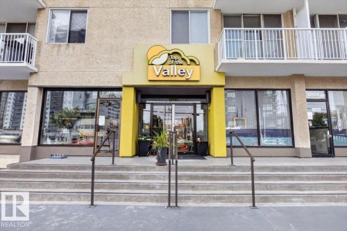 Concrete exterior with multiple balconies featuring white railings - #506 12121 Jasper Av Nw, Edmonton, AB - Outdoor
