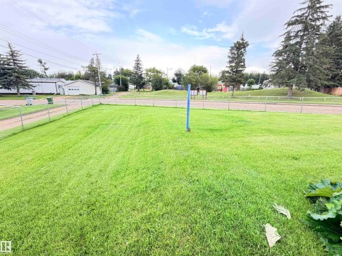 Expansive grassy yard with chain-link fencing - 9940 110 Street, Westlock, AB - Outdoor