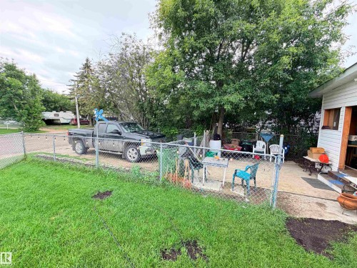 Chain link fencing enclosing a gravel parking area and concrete patio - 9940 110 Street, Westlock, AB - Outdoor