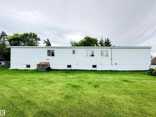 White horizontal siding exterior with multiple windows - 9940 110 Street, Westlock, AB - Outdoor