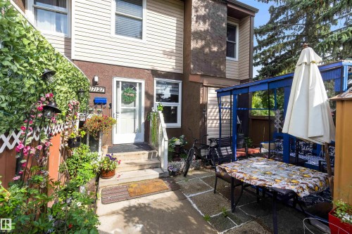 Entryway featuring an exterior door, adjacent windows, and a multi-level concrete staircase - 17127 109 Street Nw, Edmonton, AB - Outdoor
