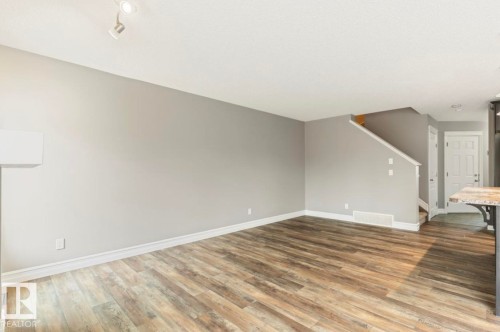 Wood-finish flooring throughout, light gray wall tones, and white trim - 79 Catalina Crest, Fort Saskatchewan, AB - Indoor Photo Showing Other Room