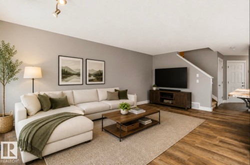 Warm wood-finish flooring complements the neutral wall color - 79 Catalina Crest, Fort Saskatchewan, AB - Indoor Photo Showing Living Room