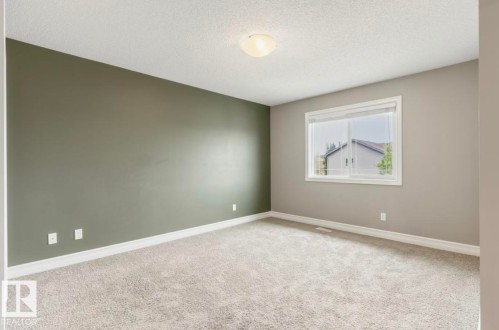 Neutral-toned carpeting, white trim, a single window, and a ceiling-mounted light fixture - 79 Catalina Crest, Fort Saskatchewan, AB - Indoor Photo Showing Other Room