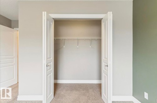 Interior closet with bifold doors, wire shelving, and neutral wall paint - 79 Catalina Crest, Fort Saskatchewan, AB - Indoor Photo Showing Other Room