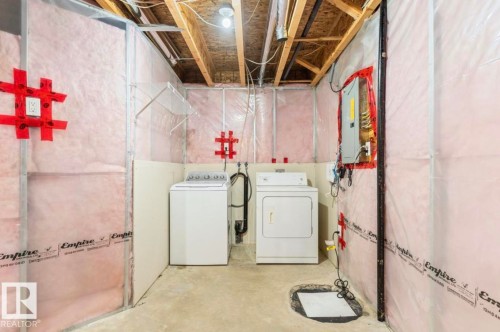 Unfinished basement space with exposed ceiling joists and insulation - 79 Catalina Crest, Fort Saskatchewan, AB - Indoor Photo Showing Laundry Room