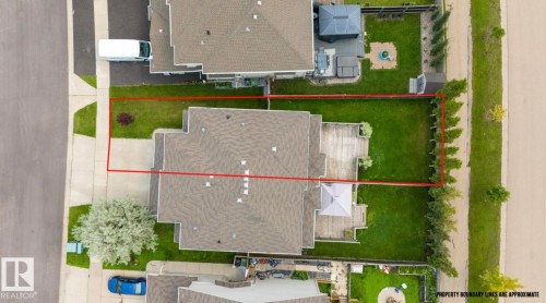 Expansive property with a large, manicured lawn, a spacious outdoor deck, and established perimeter landscaping - 79 Catalina Crest, Fort Saskatchewan, AB - Other