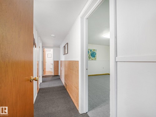 Hallway with wood-look wainscoting and gray carpet - 6112 105A Street Nw, Edmonton, AB - Indoor Photo Showing Other Room