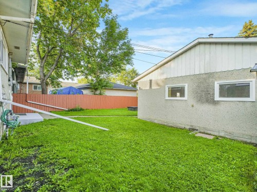 Expansive green space featuring a privacy fence and mature trees - 6112 105A Street Nw, Edmonton, AB - Outdoor