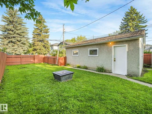 Detached garage with stucco exterior, multiple windows, and a side entry door - 6112 105A Street Nw, Edmonton, AB - Outdoor