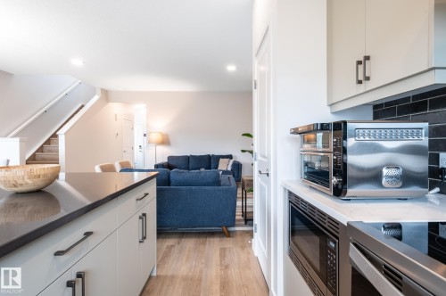 4804 Cawsey Terrace Sw, Edmonton, AB - Indoor Photo Showing Kitchen With Fireplace