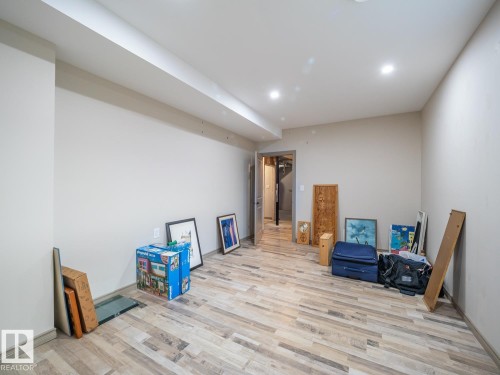Recessed lighting illuminating the expansive room with wood-finish flooring - 97 Astoria Point(E), Devon, AB - Indoor
