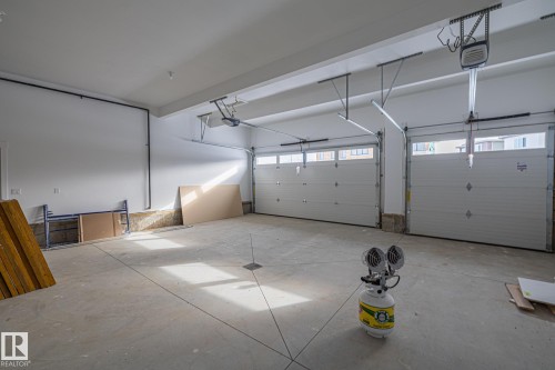 Triple Car Heated Garage with side door entry. - 28 Harley Way, Spruce Grove, AB - Indoor Photo Showing Garage