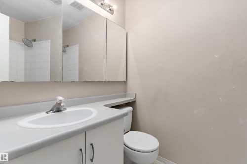 Vanity with integrated sink, chrome faucet, and cabinet storage - 851 112A Street Nw, Edmonton, AB - Indoor Photo Showing Bathroom