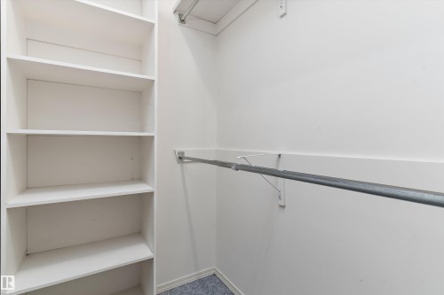 Integrated shelving unit with multiple shelves and a metal hanging rod - 851 112A Street Nw, Edmonton, AB - Indoor With Storage