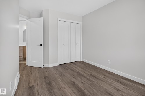 Wood-finish flooring, white walls, and a bi-fold closet door - 229 Hillcrest Crest, Sherwood Park, AB - Indoor Photo Showing Other Room