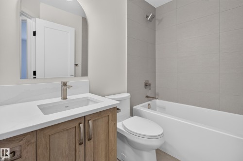 Wood-finish vanity with an integrated sink, brushed nickel faucet, and a white countertop - 229 Hillcrest Crest, Sherwood Park, AB - Indoor Photo Showing Bathroom