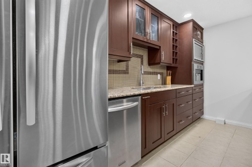 Stainless steel refrigerator, integrated dishwasher, and built-in microwave - 229 Hillcrest Crest, Sherwood Park, AB - Indoor Photo Showing Kitchen