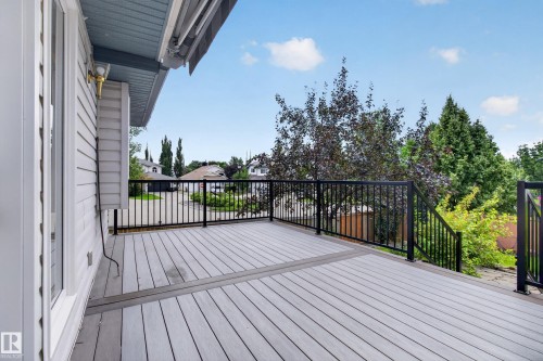 Expansive outdoor deck with gray composite decking, black metal railings, and a light-colored siding exterior - 229 Hillcrest Crest, Sherwood Park, AB - Outdoor With Deck Patio Veranda With Exterior