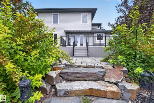 Fiber cement siding exterior with a multi-level deck featuring black railings and steps - 229 Hillcrest Crest, Sherwood Park, AB - Outdoor With Deck Patio Veranda