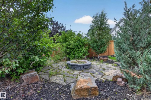 Flagstone patio featuring a stone fire pit and surrounding boulders - 229 Hillcrest Crest, Sherwood Park, AB - Outdoor