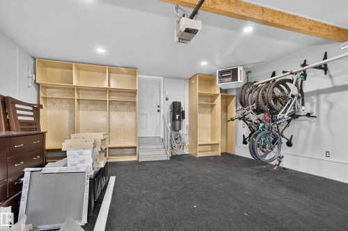 Built-in wood-finish shelving, overhead track lighting, exposed wood ceiling beams, and a durable floor covering - 229 Hillcrest Crest, Sherwood Park, AB - Indoor