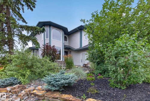 Multi-level exterior with light-colored siding, arched windows, and a dark roof - 229 Hillcrest Crest, Sherwood Park, AB - Outdoor
