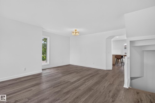 Expansive room with wood-finish flooring, white walls, recessed window, and contemporary ceiling light fixture - 229 Hillcrest Crest, Sherwood Park, AB - Indoor Photo Showing Other Room
