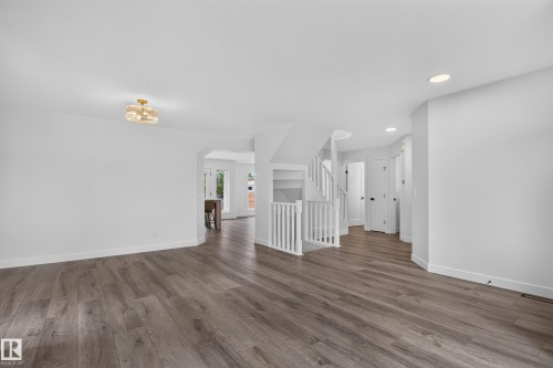 Expansive interior with wood-finish flooring, recessed lighting, and a modern ceiling fixture - 229 Hillcrest Crest, Sherwood Park, AB - Indoor Photo Showing Other Room