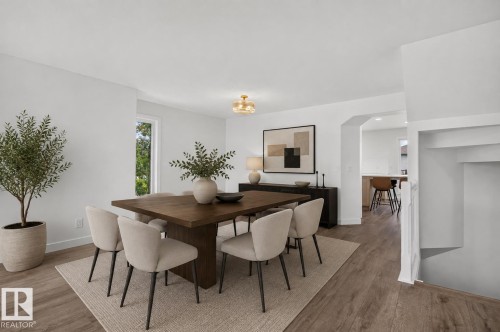 Dining area featuring wood-finish flooring, a contemporary ceiling light fixture, and a recessed window - 229 Hillcrest Crest, Sherwood Park, AB - Indoor Photo Showing Dining Room