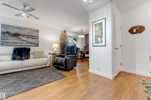 Vaulted ceilings with a ceiling fan, wood-finish flooring, and white interior doors - 6008 37 Avenue Nw, Edmonton, AB - Indoor Photo Showing Living Room