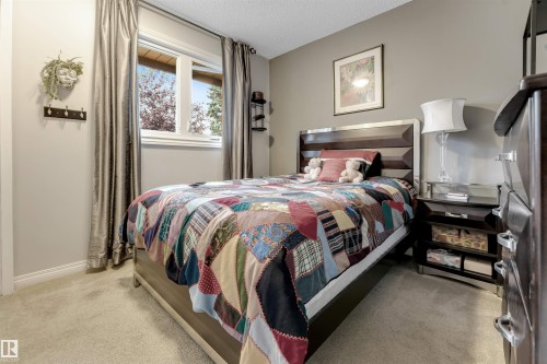 Carpeted flooring, window with natural light, neutral wall colors, dark wood-finish furniture - 6008 37 Avenue Nw, Edmonton, AB - Indoor Photo Showing Bedroom