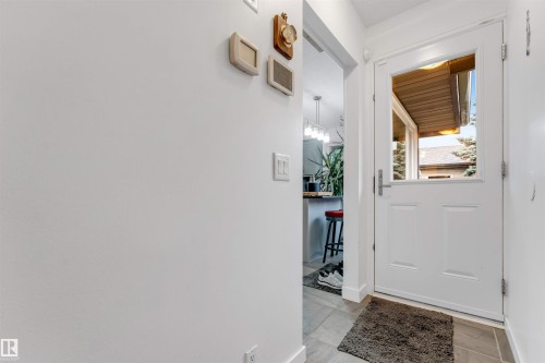 White paneled entry door with glass insert, tiled flooring, and light wall finishes - 6008 37 Avenue Nw, Edmonton, AB - Indoor Photo Showing Other Room