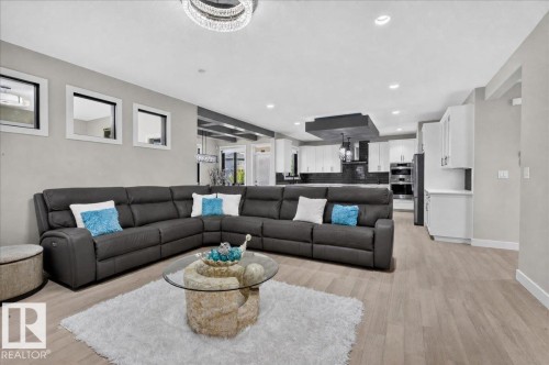 Open-concept living space featuring light wood-finish flooring - 6813 Knox Loop Sw, Edmonton, AB - Indoor Photo Showing Living Room