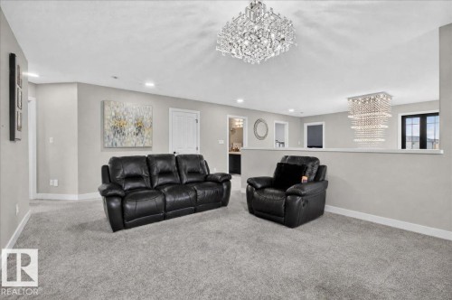 Recessed lighting, two crystal chandeliers, light gray carpeting, light gray walls, and white trim - 6813 Knox Loop Sw, Edmonton, AB - Indoor