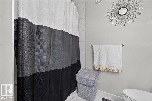 White wall tile shower surround, chrome towel bar - 6813 Knox Loop Sw, Edmonton, AB - Indoor Photo Showing Bathroom