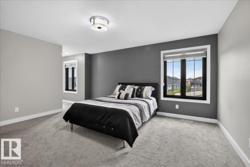Light gray carpeting throughout, featuring a dark accent wall - 6813 Knox Loop Sw, Edmonton, AB - Indoor Photo Showing Bedroom
