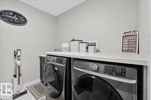 Laundry area with light-colored walls and white flooring - 6813 Knox Loop Sw, Edmonton, AB - Indoor Photo Showing Laundry Room