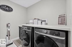 Laundry area with light-colored walls and white flooring - 