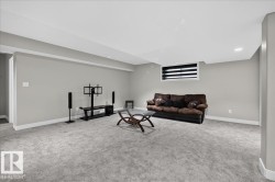 Spacious room featuring gray carpet, light gray walls, white trim, and a window with horizontal blinds - 