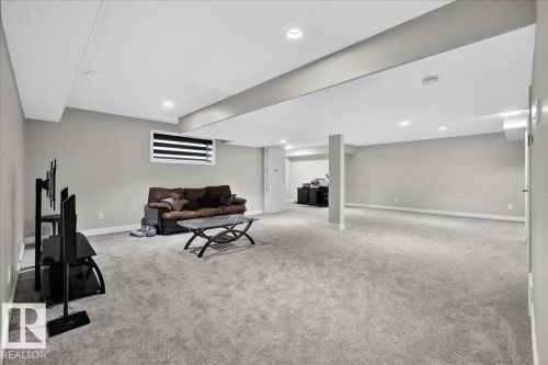 Expansive room featuring recessed lighting, a neutral color palette, and gray carpeting - 6813 Knox Loop Sw, Edmonton, AB - Indoor Photo Showing Basement